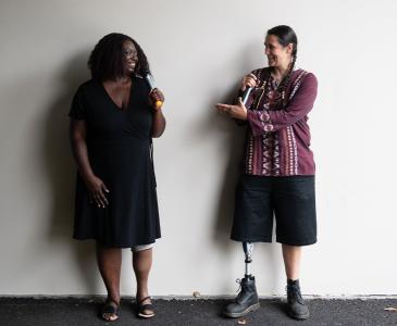 Two people with disabilities talking 